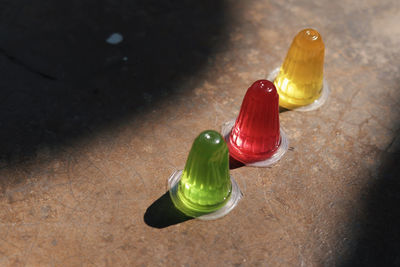 High angle view of multi colored glass bottle on table