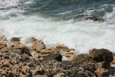 High angle view of rocks on shore at sea