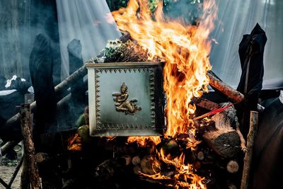 Low angle view of bonfire on wooden log