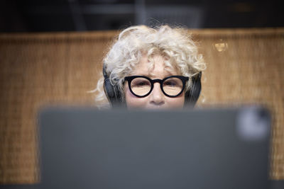 Senior woman with headphones using tablet