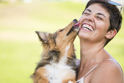 Close-up of dog licking woman