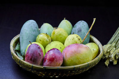 High angle view of fruits in basket on table