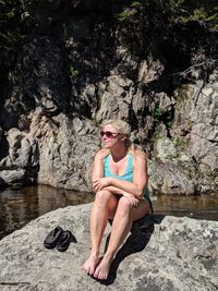 Woman sitting on rock