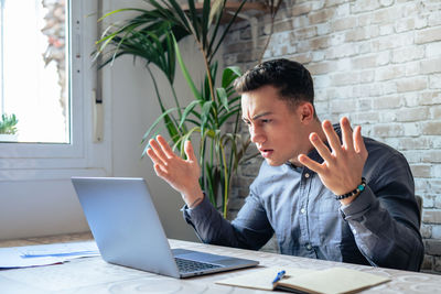 Young man using laptop at office