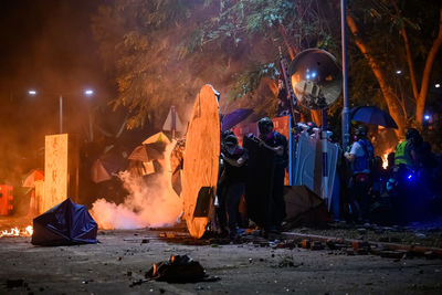 Group of people by fire at night