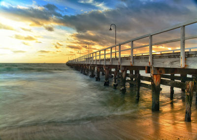 Scenic view of beach against sky during sunset