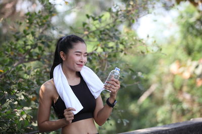 Young woman drinking water from bottle