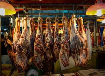 Raw meat hanging for sale at market