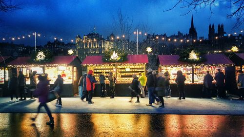 People in illuminated city at night