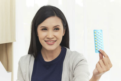 Woman holding pills