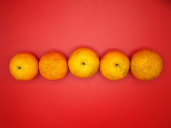 Close-up of fruits against orange background