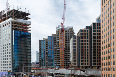 Low angle view of buildings and construction against sky in city. boston 