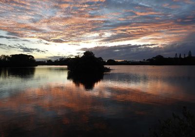 Scenic view of lake against sky during sunset