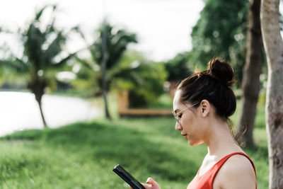 Portrait of a young woman holding plant