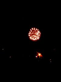 Low angle view of firework display at night