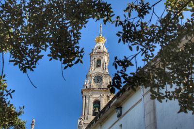 Low angle view of clock tower against sky