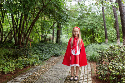 Portrait of smiling girl wearing costume standing at park