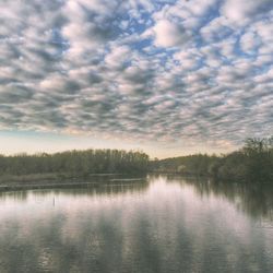 Scenic view of lake against cloudy sky