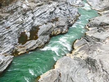 High angle view of rocks on sea shore