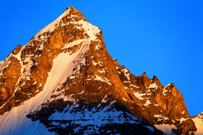 Low angle view of rocky mountain during winter at gran paradiso national park