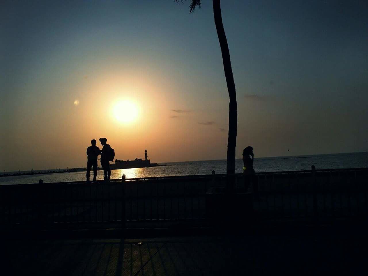 silhouette, sky, sea, water, sunset, real people, scenics - nature, beauty in nature, nature, beach, lifestyles, leisure activity, horizon over water, standing, men, sun, horizon, land, orange color, outdoors, promenade