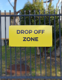 Close-up of warning sign on fence