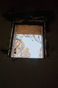 Low angle view of building seen through window