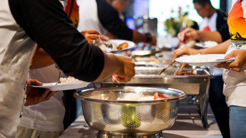 Close-up of people preparing food