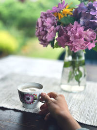 Cropped hand of woman using mobile phone