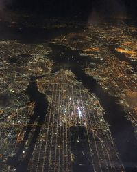 High angle view of city lit up at night