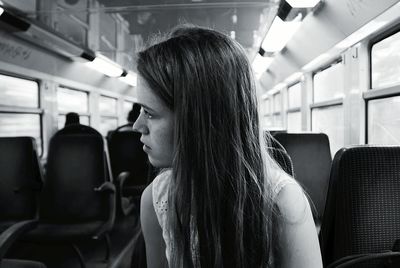 Young woman with long hair sitting in train