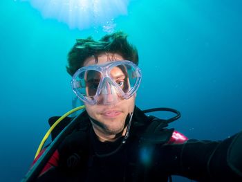 Close-up of man scuba diving in sea