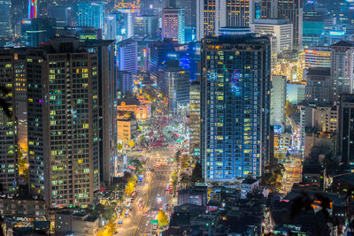 Aerial view of city lit up at night