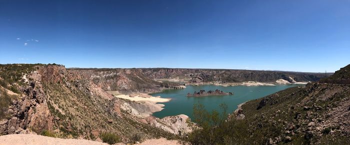 Scenic view of river against clear blue sky