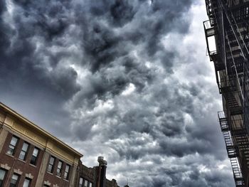 Low angle view of buildings against cloudy sky