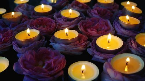 High angle view of lit candles on table
