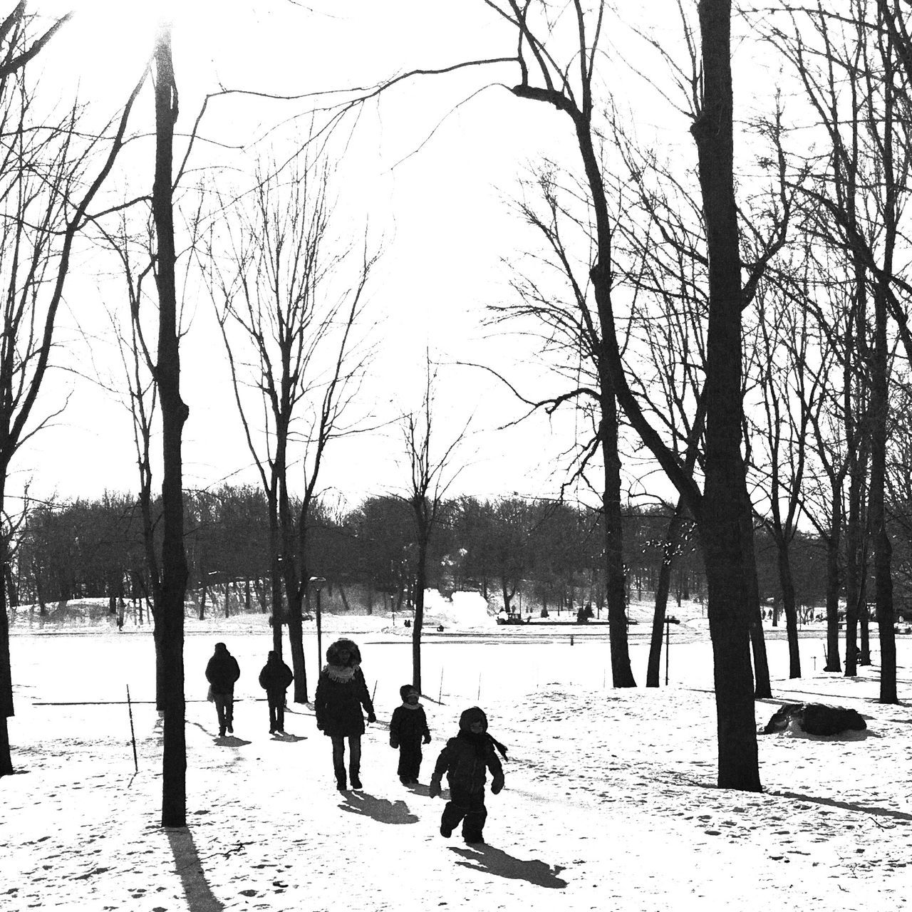 PEOPLE WALKING ON SNOW COVERED LANDSCAPE