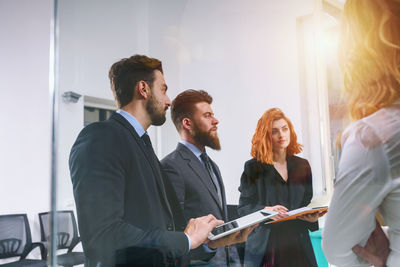 Side view of business colleagues working in office