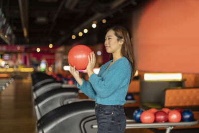 Midsection of woman holding toy in gym