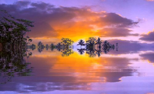Scenic view of lake against orange sky