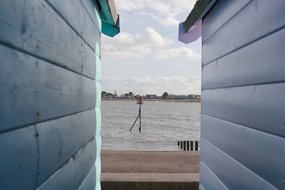 Scenic view of sea by buildings against sky