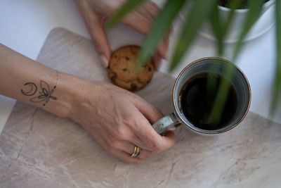 High angle view of woman holding drink