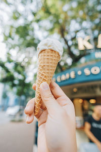 Close-up of hand holding ice cream cone