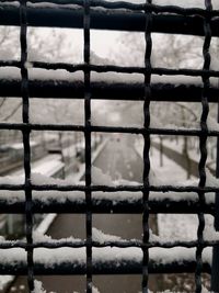 Full frame shot of metal fence during winter