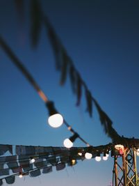  low angle view of illuminated light bulbs against sky at night