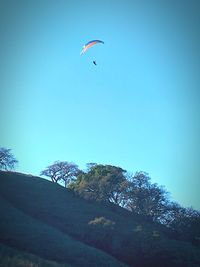 Low angle view of kite flying against clear blue sky