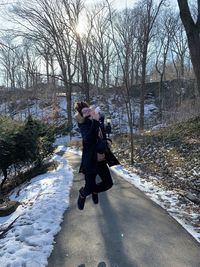 Full length of woman on snow covered field