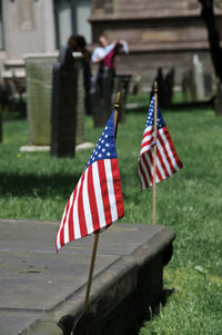 Flag against blue sky at cemetery