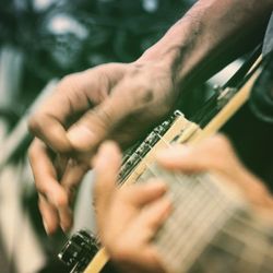 Midsection of person playing guitar