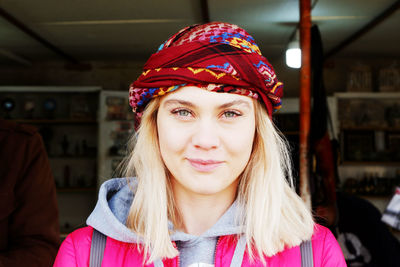 Portrait of smiling young woman wearing headscarf